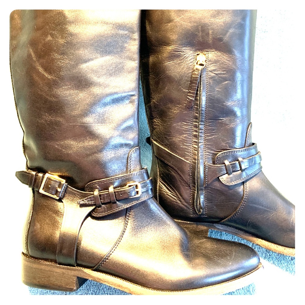 Burberry bridle strap knee height riding boots.